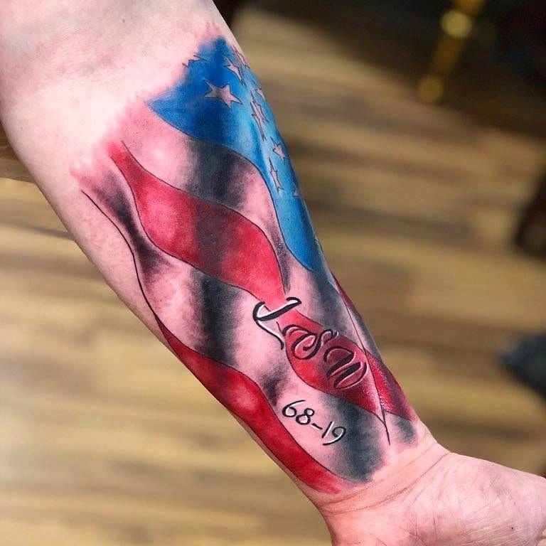 Black and grey American flag design tattoo on hand, patriotic artwork